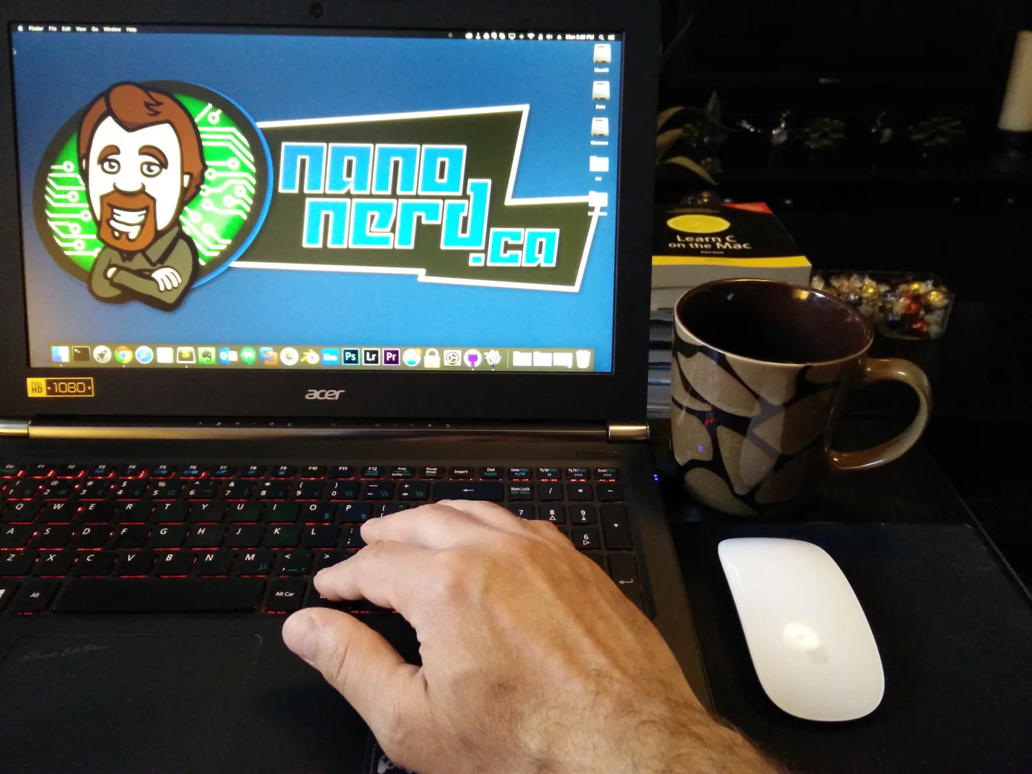 Kayhan sitting in front of laptop blogging with cup of coffee